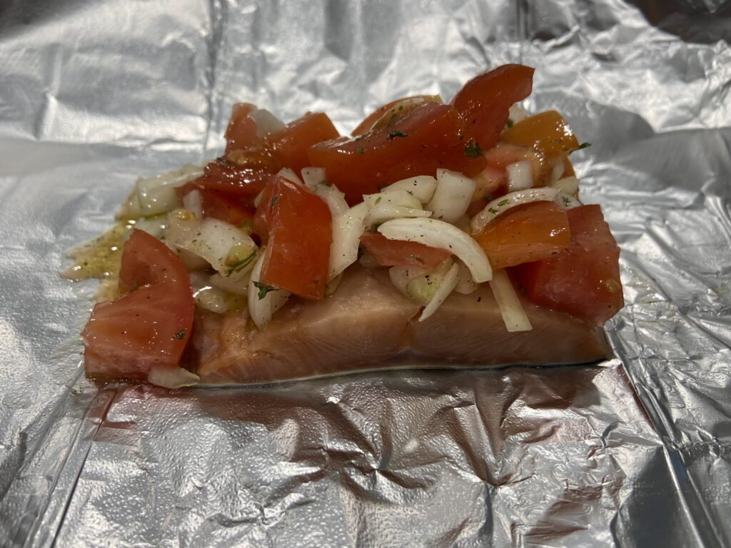 salmon, chopped onion, salt, pepper, and extra virgin olive oil in a foil packet
