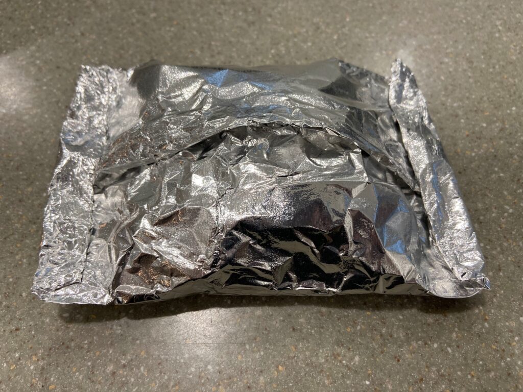 salmon, chopped onion, salt, pepper, and extra virgin olive oil in a foil packet