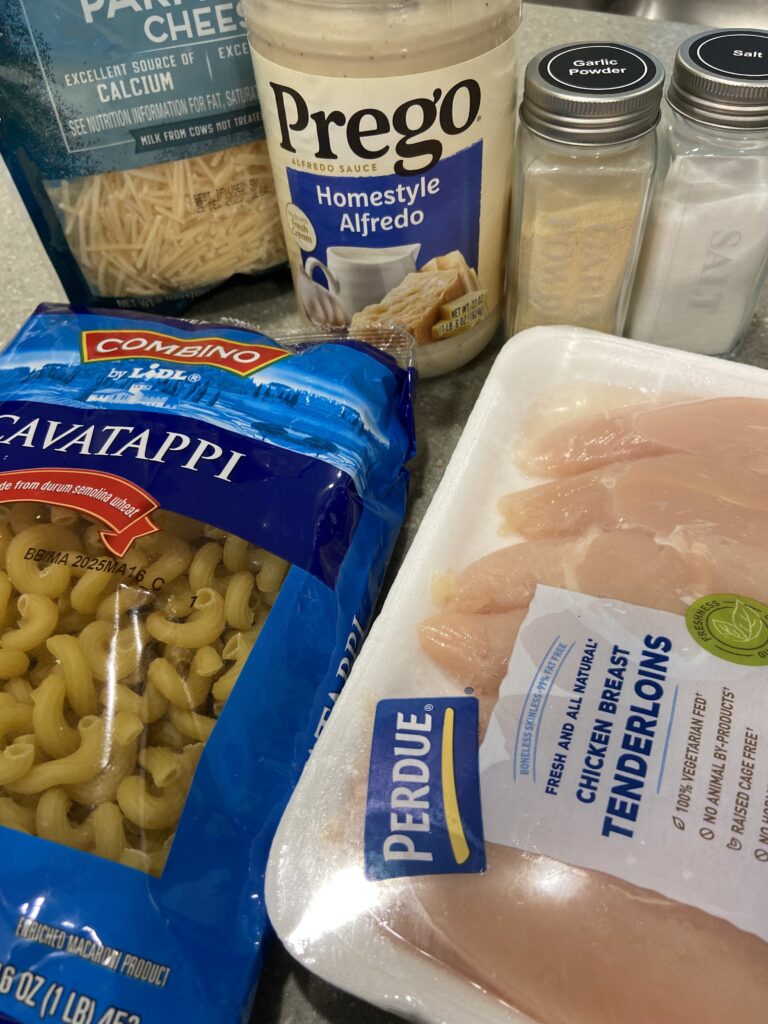 List of ingredients, cavatappi pasta, chicken tenders, alfredo sauce, shredded cheese and seasonings