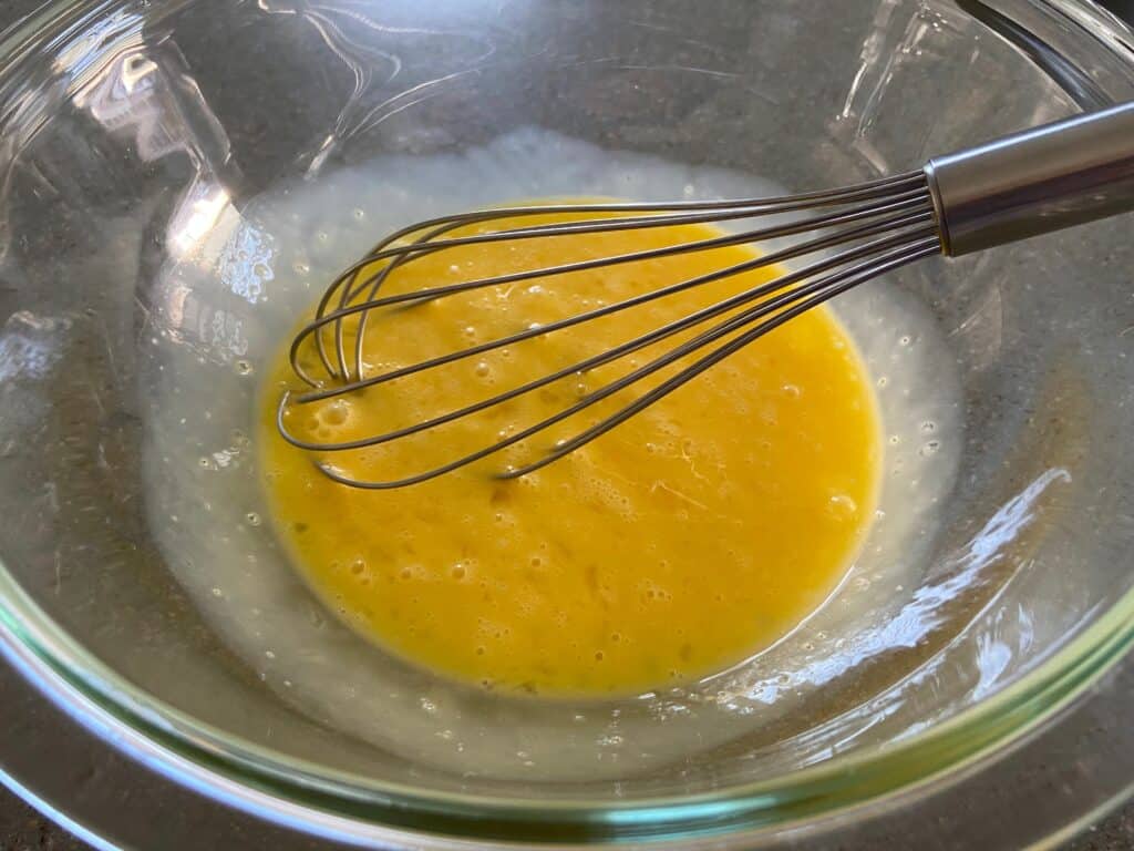 Eggs in a bowl with a whisk