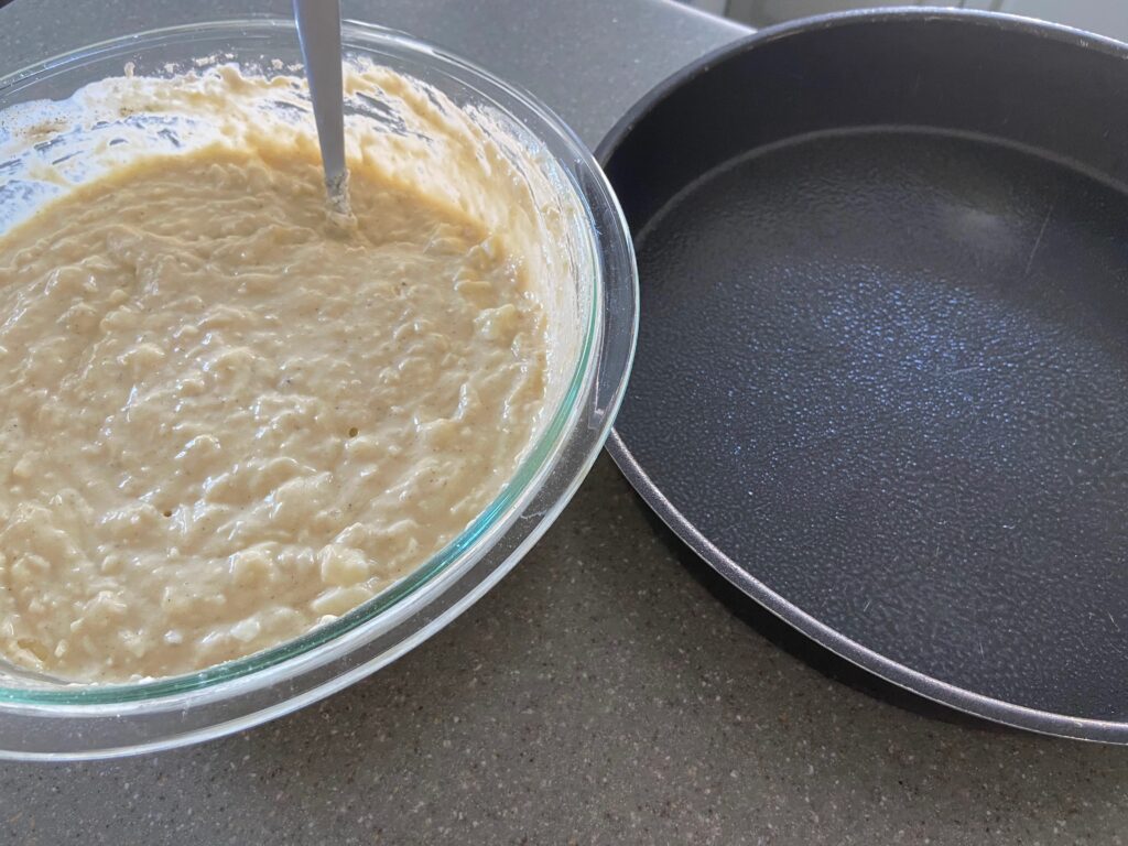 cheesy mixture added to a round baking pan