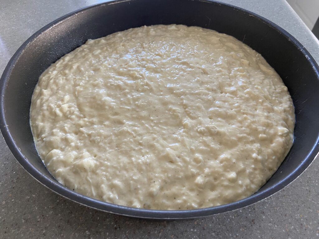 cheesy mixture added to a round baking pan