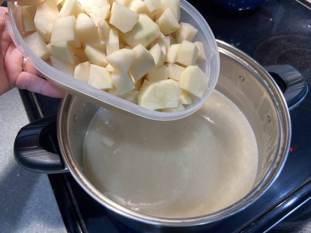 potatoes cut into cubes added to a pot of boiling water