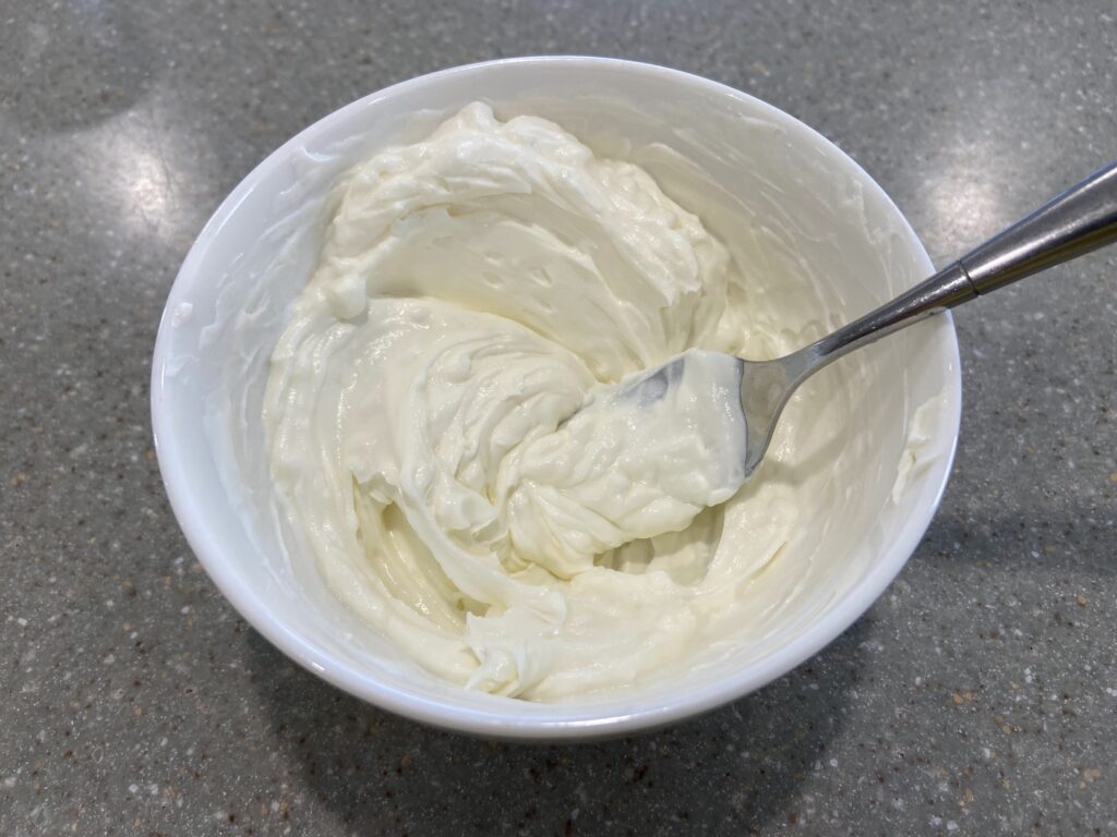 Cream cheese and sour cream combined in a small bowl