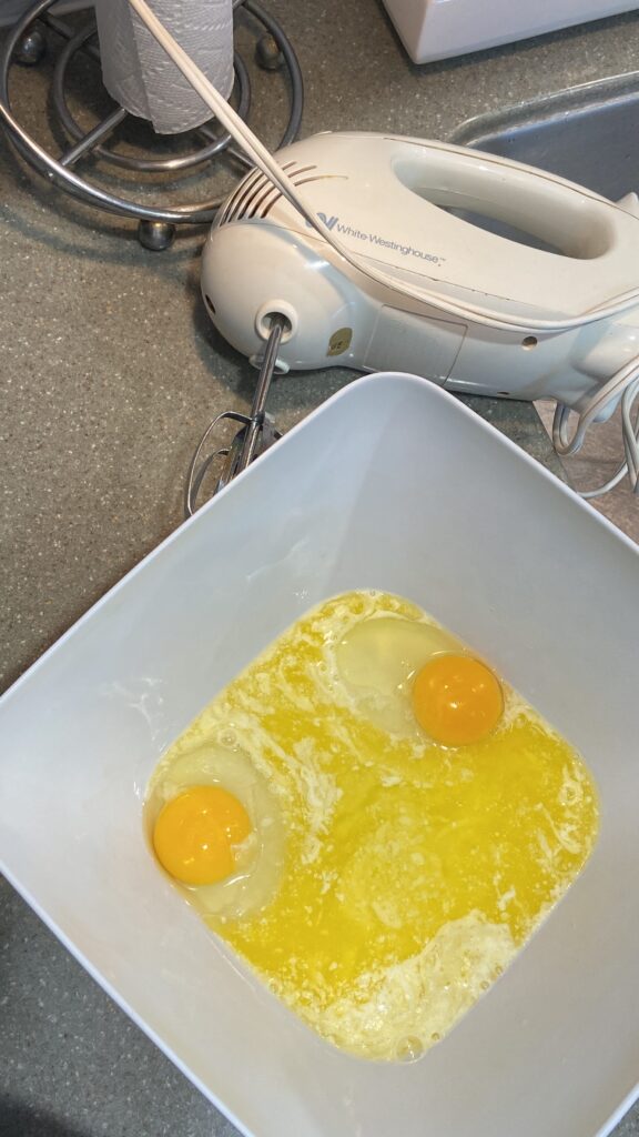 2 eggs cracked in a bowl 
add melted butter