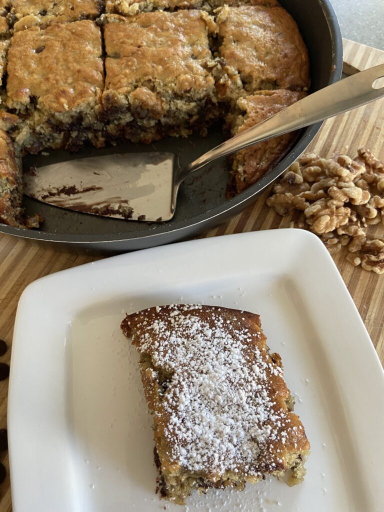 banana cake
banana bread
chocolate chip
walnuts
sliced banana walnut chocolate chip cake in a pan 
banana bread sprinkled with powdered sugar
