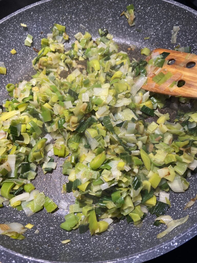 chopped leeks sautéed in pan with olive oil