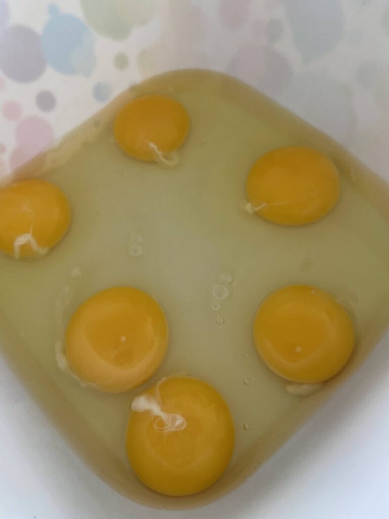 6 eggs cracked in a large mixing bowl