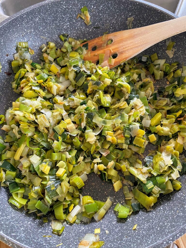 chopped leeks sautéed in pan with olive oil until golden brown