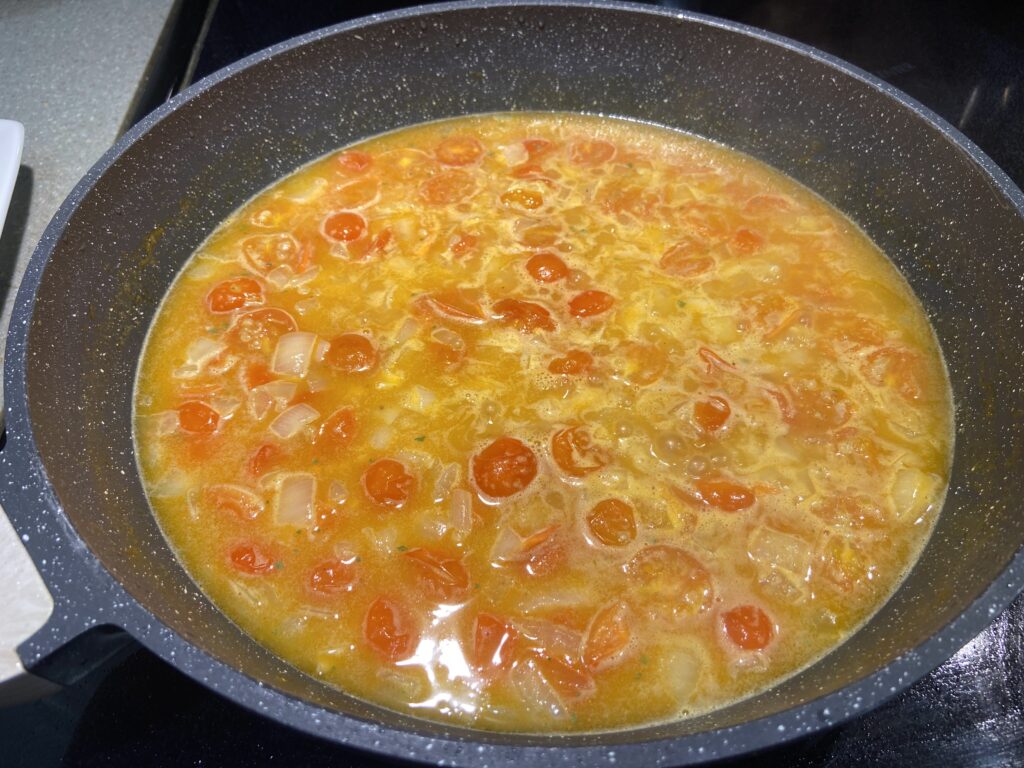 blistered cherry tomatoes with chopped onion and couscous