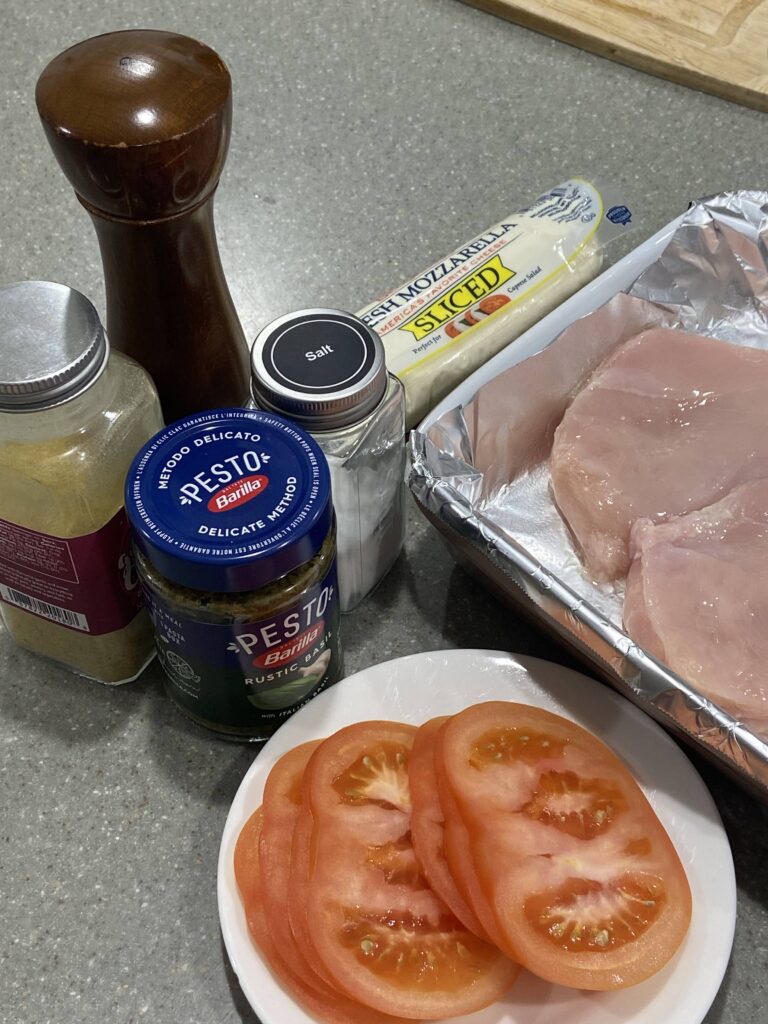 chicken breast
fresh sliced mozzarella cheese
basil garlic pesto
salt, pepper
baking dish
sliced tomatoes