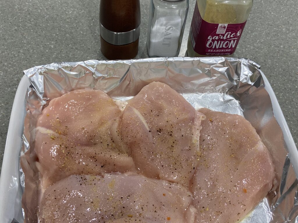 seasoned chicken breast cutlets arranged in a baking dish