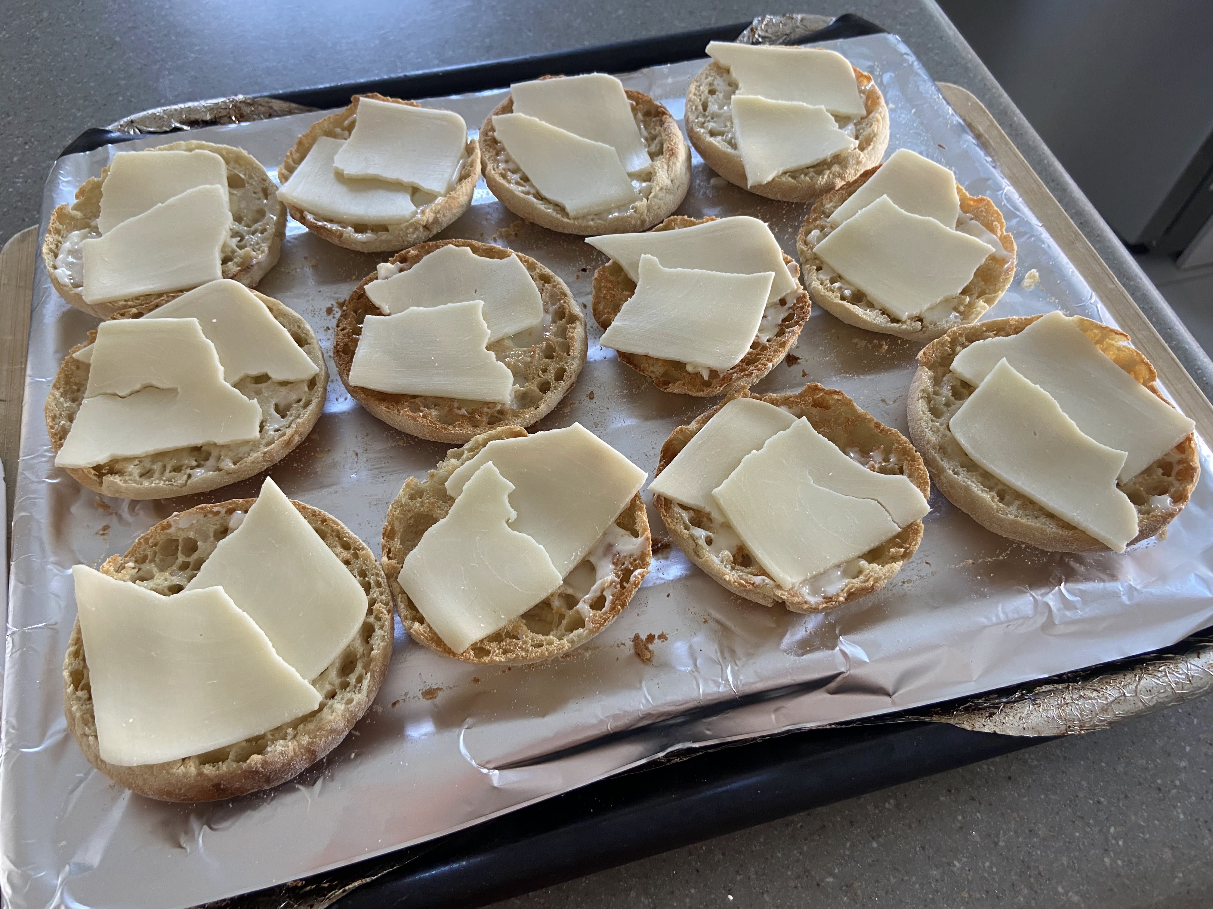 cheese on top of toasted English muffin