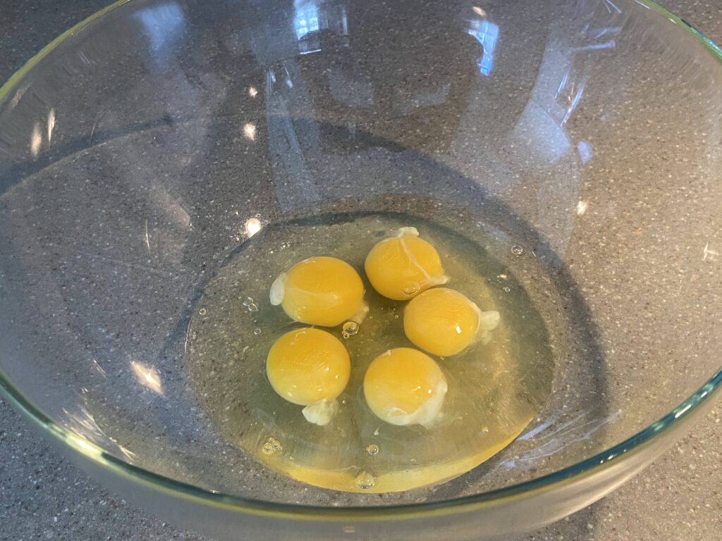 5 eggs cracked in a bowl