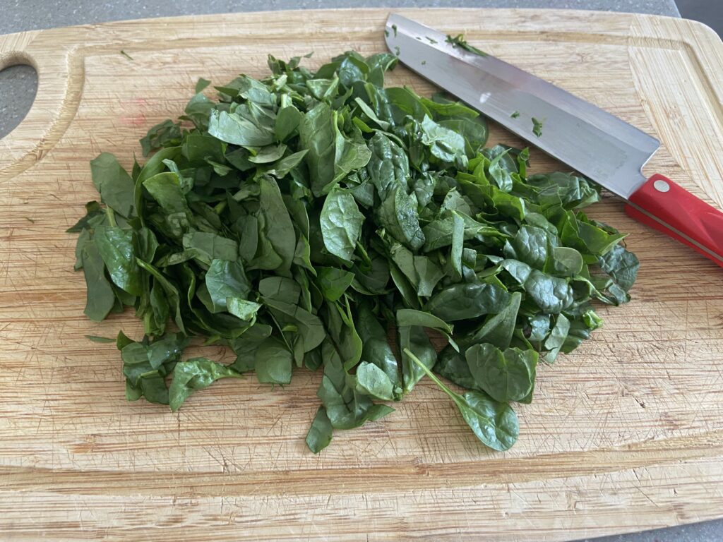 chopped spinach added to the slow cooker