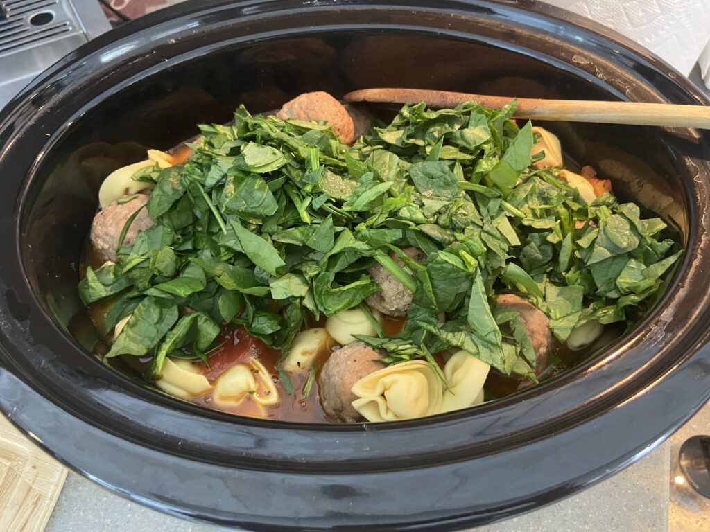 chopped spinach and cheese tortellini added to the clow cooker