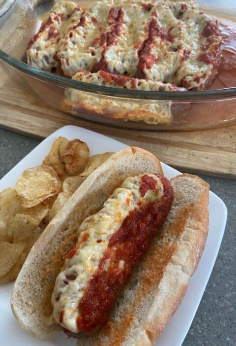 A plate with a hot dog and chips.