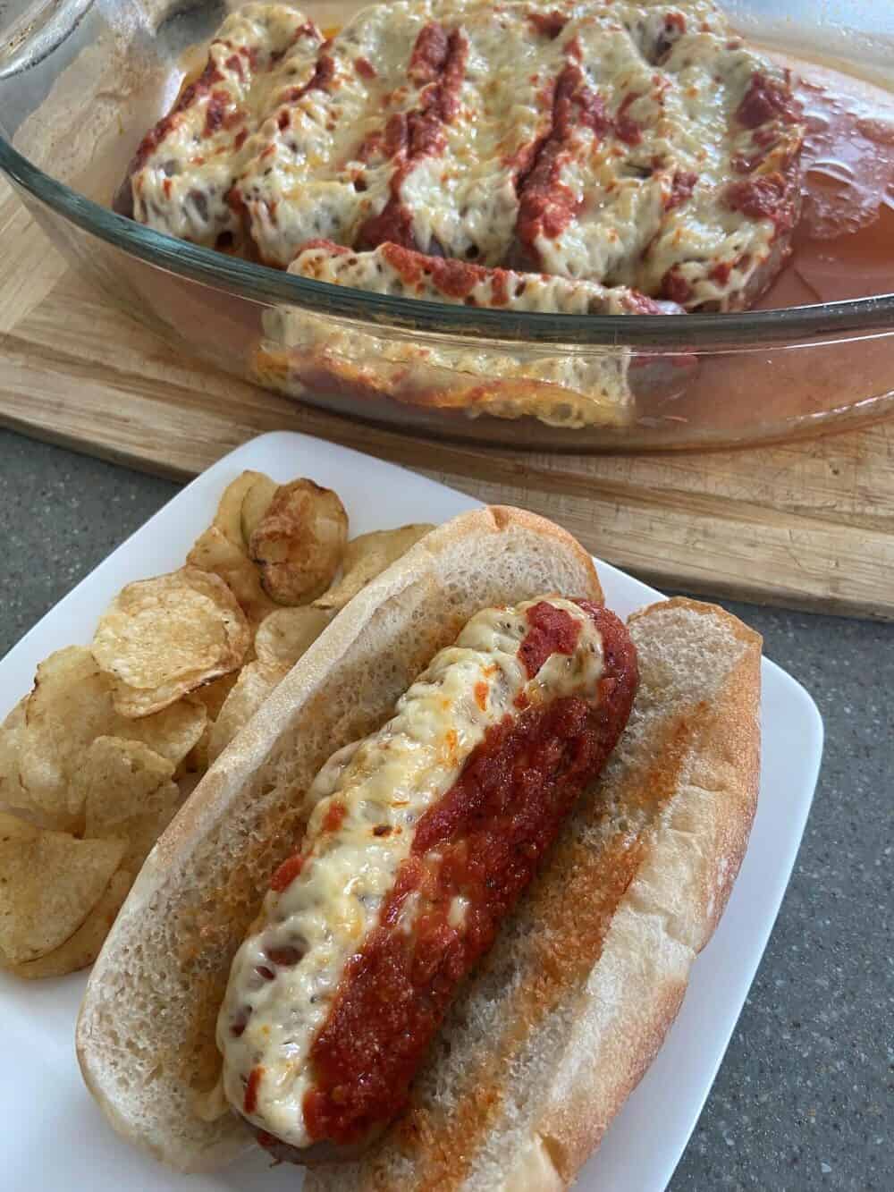 A plate with a hot dog and chips.